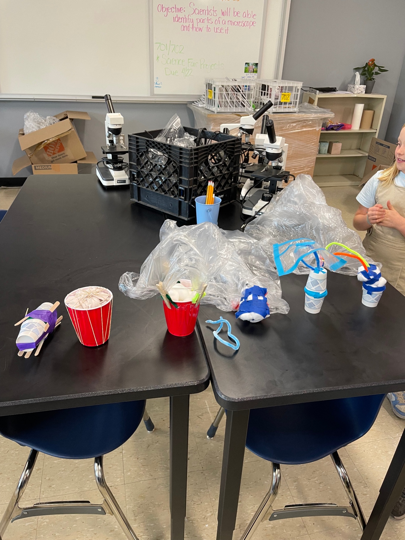 Student-built egg-drop parachute prototypes displayed on a classroom table